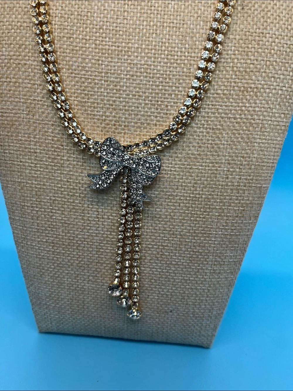 #0145.  Macy's Gold-Tone Crystal Bow Lariat Necklace